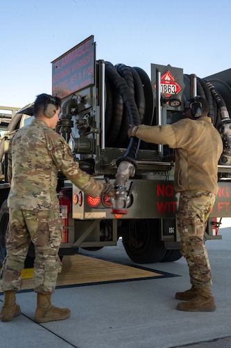 Two U.S. Airmen prepare a fuel truck to refuel a KC-47 Pegasus