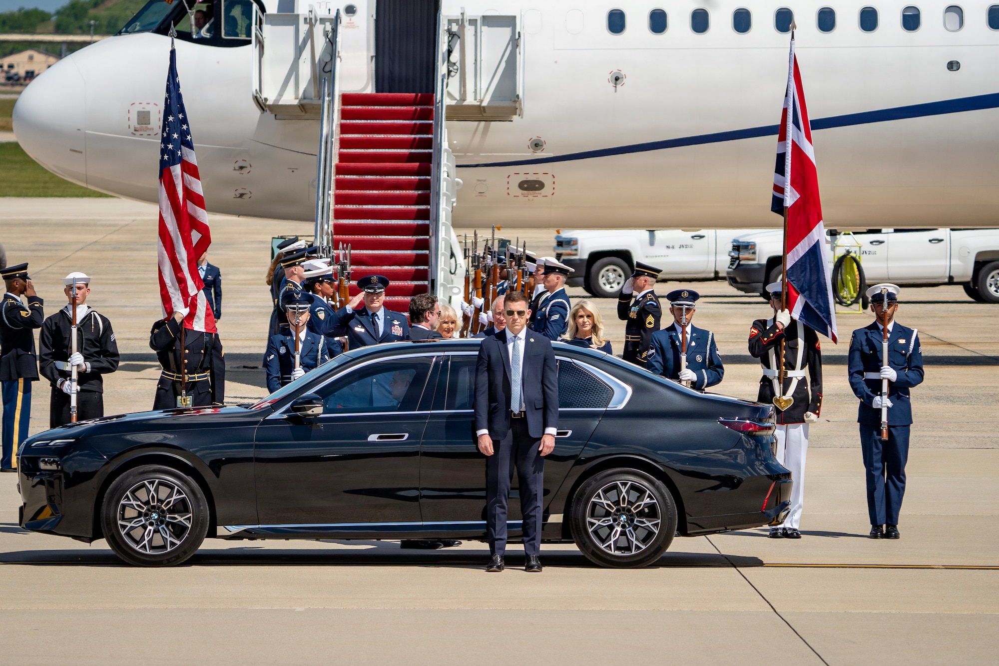 Their Majesties of the United Kingdom of Great Britain and Northern Ireland, King Charles III and Queen Camilla, prepare to enter a motorcade.