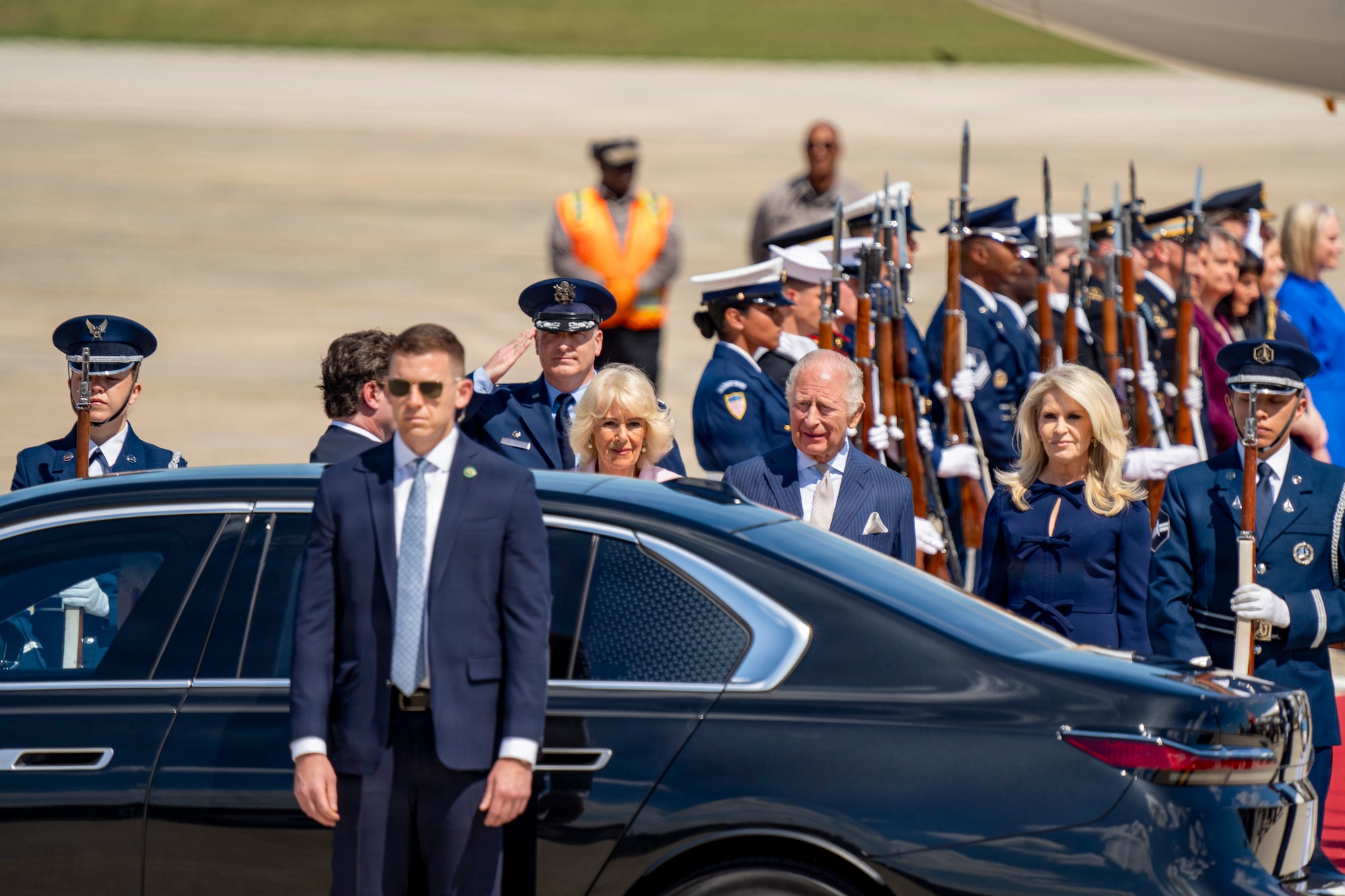 Their Majesties of the United Kingdom of Great Britain and Northern Ireland, King Charles III and Queen Camilla, prepare to enter a motorcade.