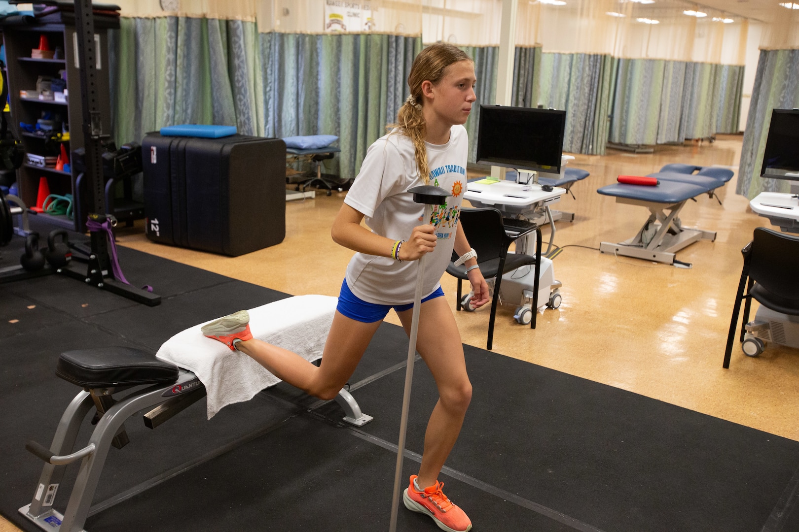 Sadie Kreuger, a student-athlete from Moanalua High School, performs rehabilitation exercises at Tripler Army Medical Center (TAMC), April 17. With support from TAMC’s physical therapy team, Kreuger recovered from injury, won the Hawaii State Cross-Country title, earned recognition as the Hawaii Gatorade Player of the Year for cross-country, and qualified to represent Team West at the Brooks Cross Country Nationals. (Defense Health Agency photos by Hugh Fleming)