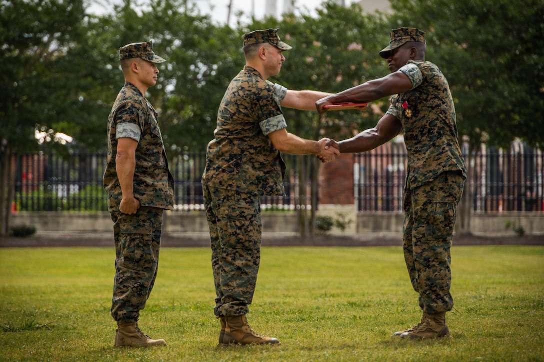 U.S. Marine Corps Sgt. Maj. Kabiru Labaran, outgoing sergeant major, receives the Legion of Merit from Col. Anthony Sferrazza, commanding officer, Headquarters Battalion, Marine Forces Reserve, Marine Forces South, during a relief and appointment ceremony at Marine Corps Support Facility New Orleans, Apr. 24. 2026. During the ceremony, Labaran relinquished his duties to Sgt. Maj. Roberto Sim, Headquarters Battalion, Marine Forces Reserve, Marine Forces South. (U.S. Marine Corps photo by Lance Cpl. Edward Spears)