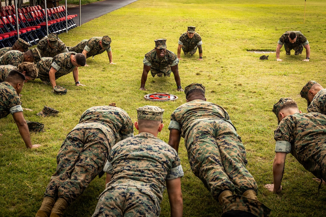 U.S. Marine Corps Sgt. Maj. Kabiru Labaran, outgoing sergeant major, Headquarters Battalion, Marine Forces Reserve, Marine Forces South, does push-ups alongside his fellow Marines before a relief and appointment ceremony at Marine Corps Support Facility New Orleans, Apr 24. 2026. Labaran relinquishes his duties to Sgt. Maj. Roberto Sim, the incoming sergeant major. (U.S. Marine Corps photo by Lance Cpl. Edward Spears)