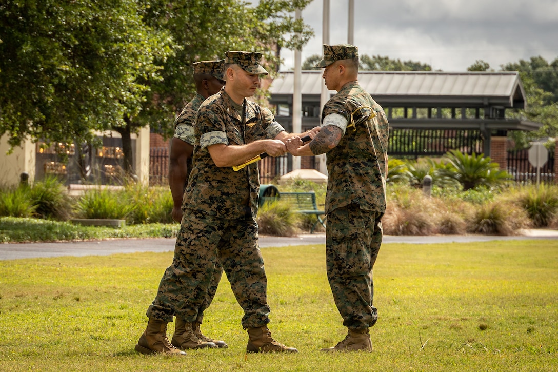 U.S. Marine Corps Sgt. Maj. Roberto Sim, incoming sergeant major, right, receives the sword of office from Col. Anthony Sferrazza, commanding officer, left, Headquarters Battalion, Marine Forces Reserve, Marine Forces South, during a relief and appointment ceremony at Marine Corps Support Facility New Orleans, Apr. 24. 2026. During the ceremony, Sgt. Maj. Kabiru Labaran relinquished his duties to Sgt. Maj. Roberto Sim, Headquarters Battalion, Marine Forces Reserve, Marine Forces South. (U.S. Marine Corps photo by Lance Cpl. Edward Spears)