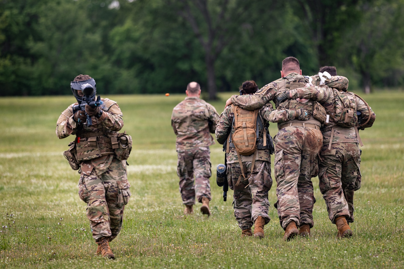 Oklahoma National Guard Soldiers simulate suppressing enemy fire while extracting a hostage during the Oklahoma Battlefield Resilience Camp at Camp Gruber Training Center near Braggs, Okla., April 23, 2026. The training emphasizes integrating resilience and behavioral health skills into squad-level tactics, ensuring Soldiers remain lethal, cohesive and prepared to respond to complex missions at home and abroad. (Oklahoma National Guard photo by Sgt. Danielle Rayon)