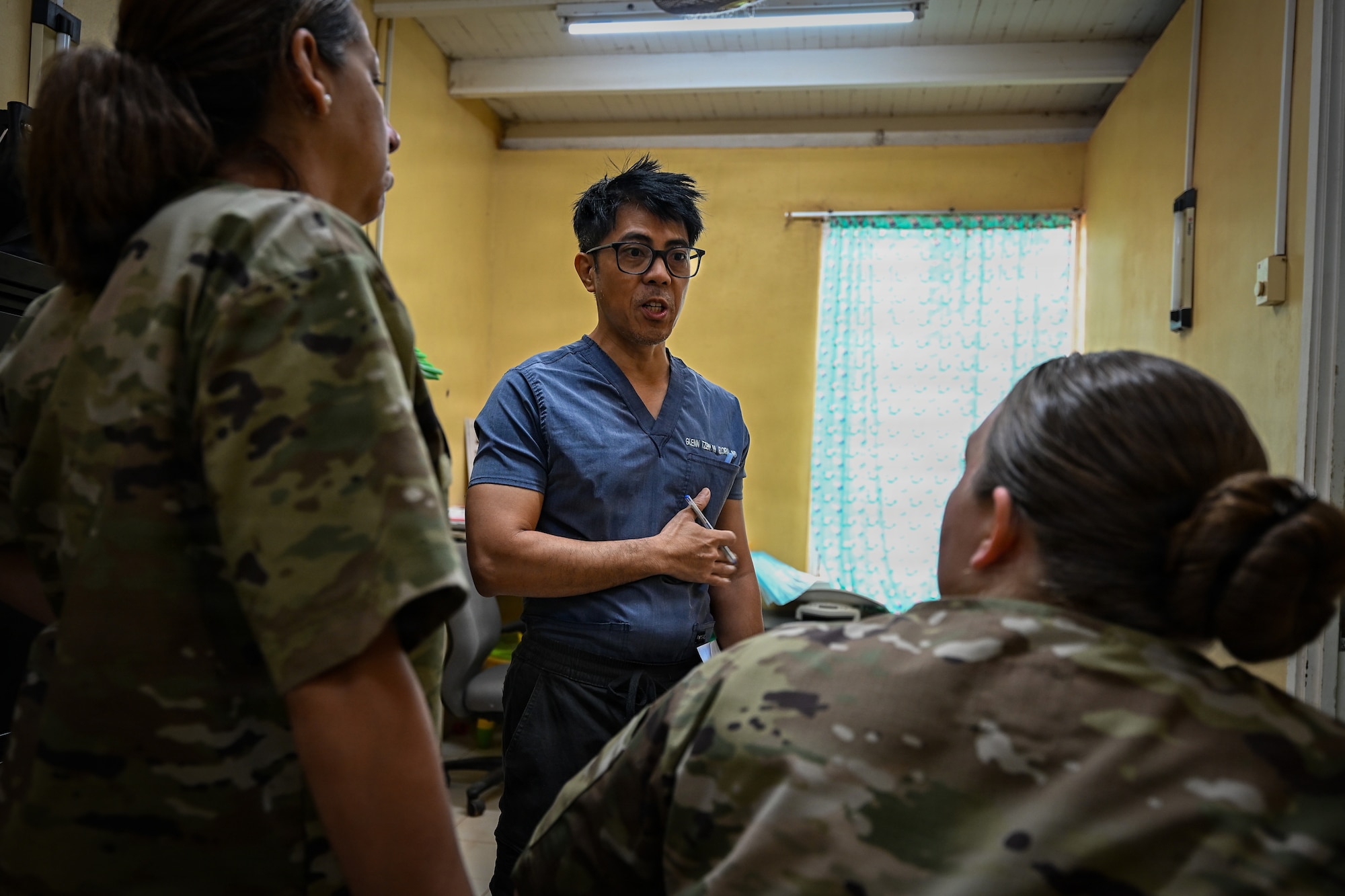 Dr. Glenn Gloria, Medische Zending Primary Health Care Center (MZ PHC) physician, talks to U.S. Air Force medical professionals during the Lesser Antilles Medical Assistance Team (LAMAT) 2026 mission at MZ PHC in Brownsweg, Suriname, April 14, 2026. Through LAMAT 2026, U.S. Air Force medical teams worked alongside local providers to share knowledge and strengthen patient care in resource-limited environments. (U.S. Air Force photo by Staff Sgt. Madeline Herzog)