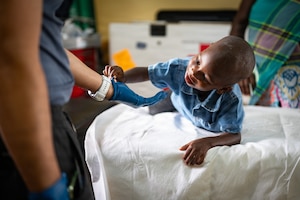 Dr. Glenn Gloria, Medische Zending Primary Health Care Center (MZ PHC) physician, reaches his hand out to a patient during the Lesser Antilles Medical Assistance Team (LAMAT) 2026 mission at MZ PHC Brownsweg, Suriname, April 14, 2026. LAMAT 2026 demonstrates how partnership and solidarity go hand-in-hand, strengthening trust between the United States and regional allies through shared humanitarian goals. (U.S. Air Force photo by Staff Sgt. Madeline Herzog)