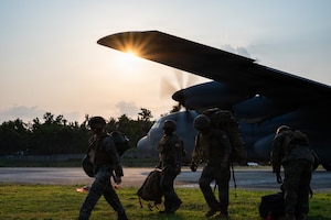 Airmen fly in a C-130J