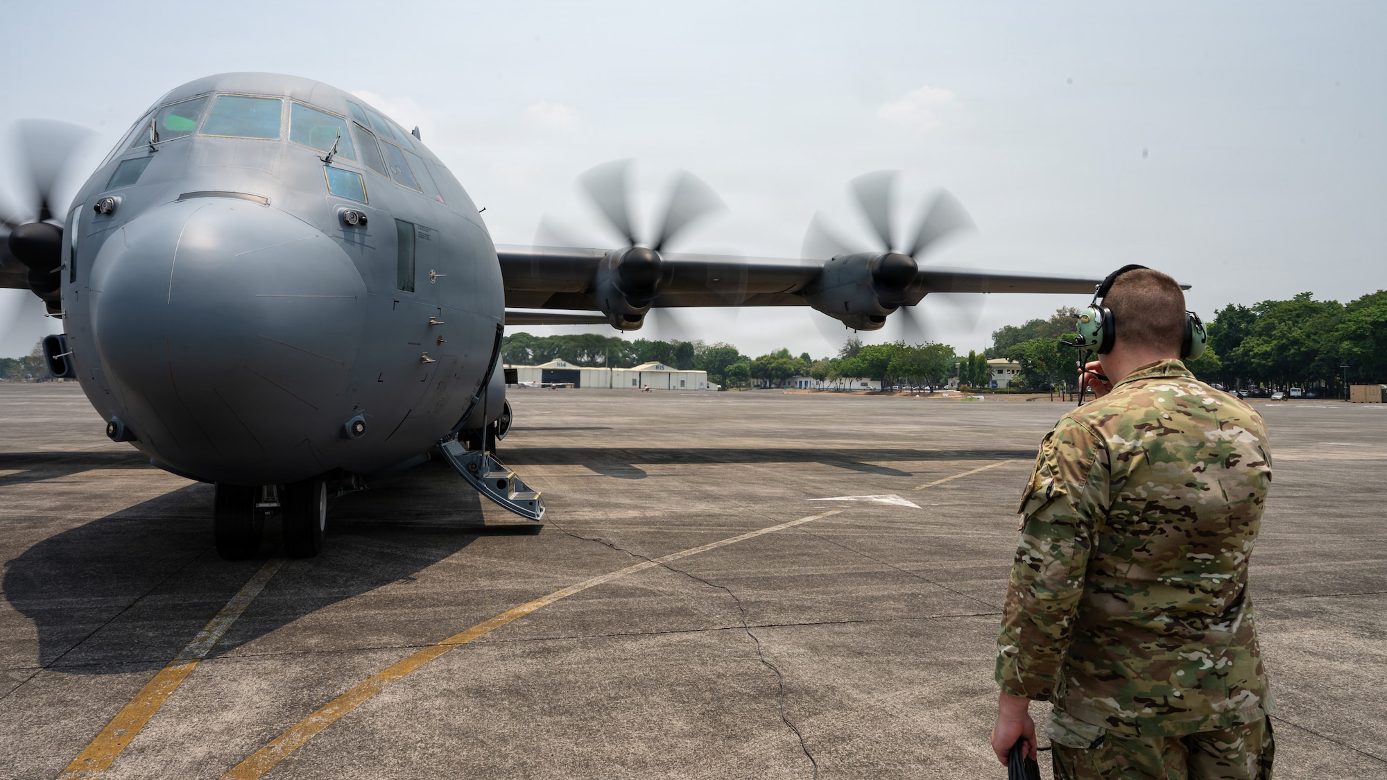 Airmen work on a C-130J