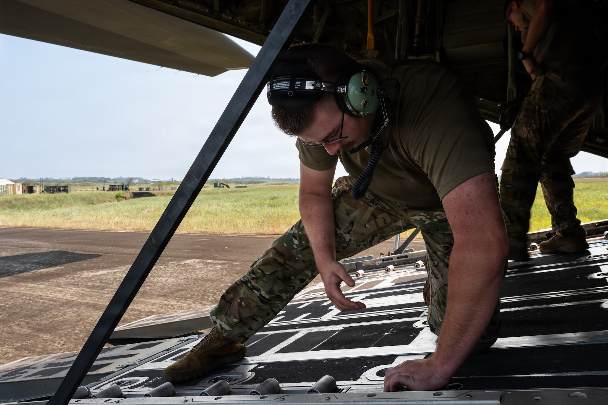 Airmen work on a C-130J