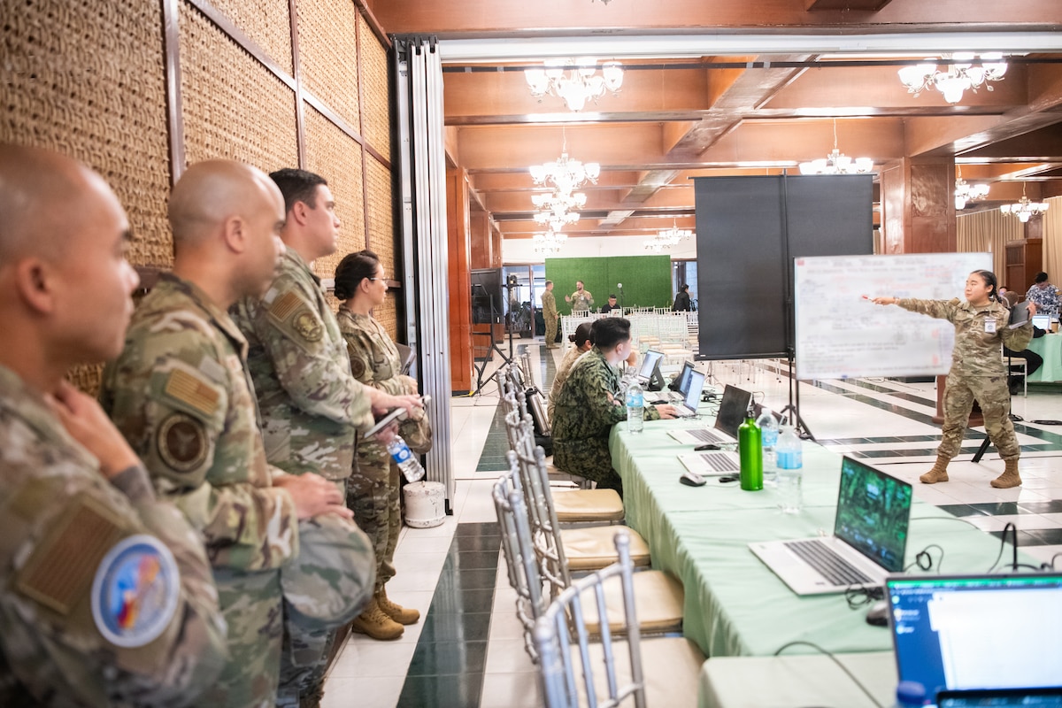 U.S. and Philippine service members listen to lecture