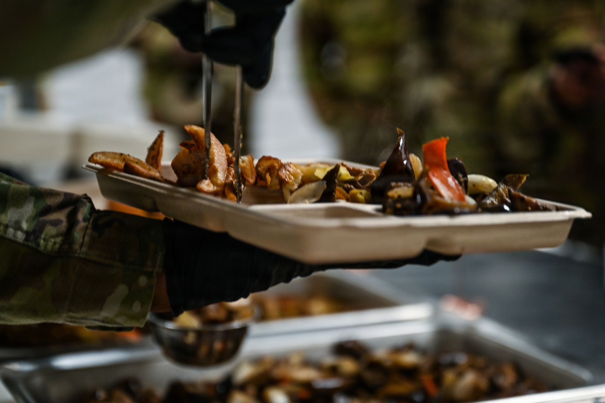 A U.S. Airman assigned to the 31st Combat Air Base Squadron serves food in the dining facility during exercise Freedom Flag 26-1 at Gwangju Air Base, Republic of Korea, April 9, 2026. Throughout the routine training event, the cross-functional teams that make up 31 CABS enhanced flexibility and enabled joint and allied warfighters to focus on the mission. (U.S. Air Force photo by Senior Airman Ty Pilgrim)