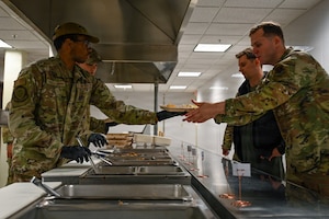 U.S. Airmen assigned to the 31st Combat Air Base Squadron distribute food to designated forces participating in exercise Freedom Flag 26-1 at Gwangju Air Base, Republic of Korea, April 9, 2026. Throughout the routine training event, the cross-functional teams that make up 31 CABS enhanced flexibility and enabled joint and allied warfighters to focus on the mission. (U.S. Air Force photo by Senior Airman Ty Pilgrim)