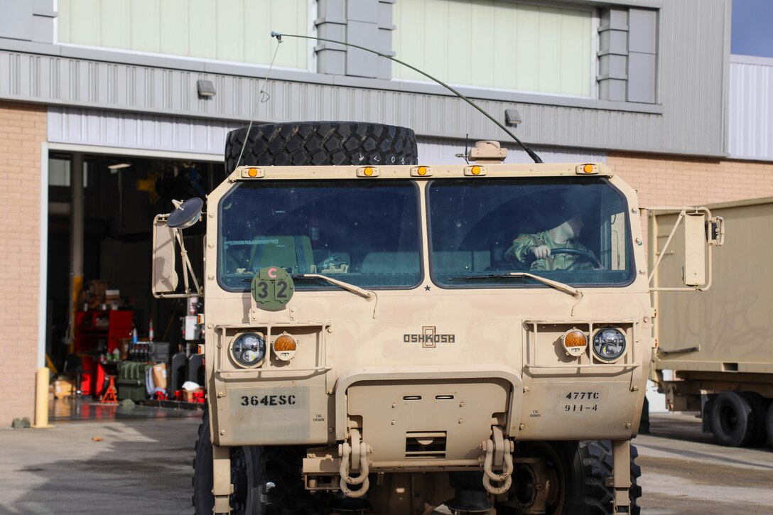 U.S. Army Reserve Staff Sgt. Christian Capovilla, 477th Inland Cargo Transportation Company, 385th Transportation Terminal Battalion, 364th Expeditionary Sustainment Command, backs a Heavy Expanded Mobility Tactical Truck wrecker into a bay before performing pre-deployment maintenance in support of U.S. Indo-Pacific Command forward positioning equipment requirements, Dec. 17, 2025. The 364th Expeditionary Sustainment Command is headquartered in Marysville, Washington, and is regionally aligned to U.S. Indo-Pacific Command, providing logistical and sustainment support across seven western states and the Indo-Pacific region. (U.S. Army Photo by Maj. India Hunter)