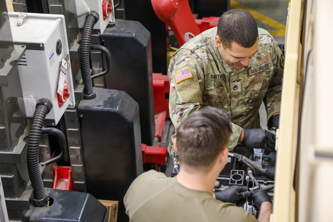 U.S. Army Reserve Staff Sgt. Noah Smith and Staff Sgt. Nicholas Orbanosky, 477th Inland Cargo Transportation Company, 385th Transportation Terminal Battalion, 364th Expeditionary Sustainment Command Soldiers, perform pre-deployment maintenance on a M1083 Medium Tactical Vehicle to ensure equipment readiness prior to forward positioning in the Indo-Pacific region, Dec. 19, 2025. The 364th Expeditionary Sustainment Command is headquartered in Marysville, Washington, and is regionally aligned to U.S. Indo-Pacific Command, providing logistical and sustainment support across seven western states and the Indo-Pacific region. (U.S. Army Photo by Maj. India Hunter)