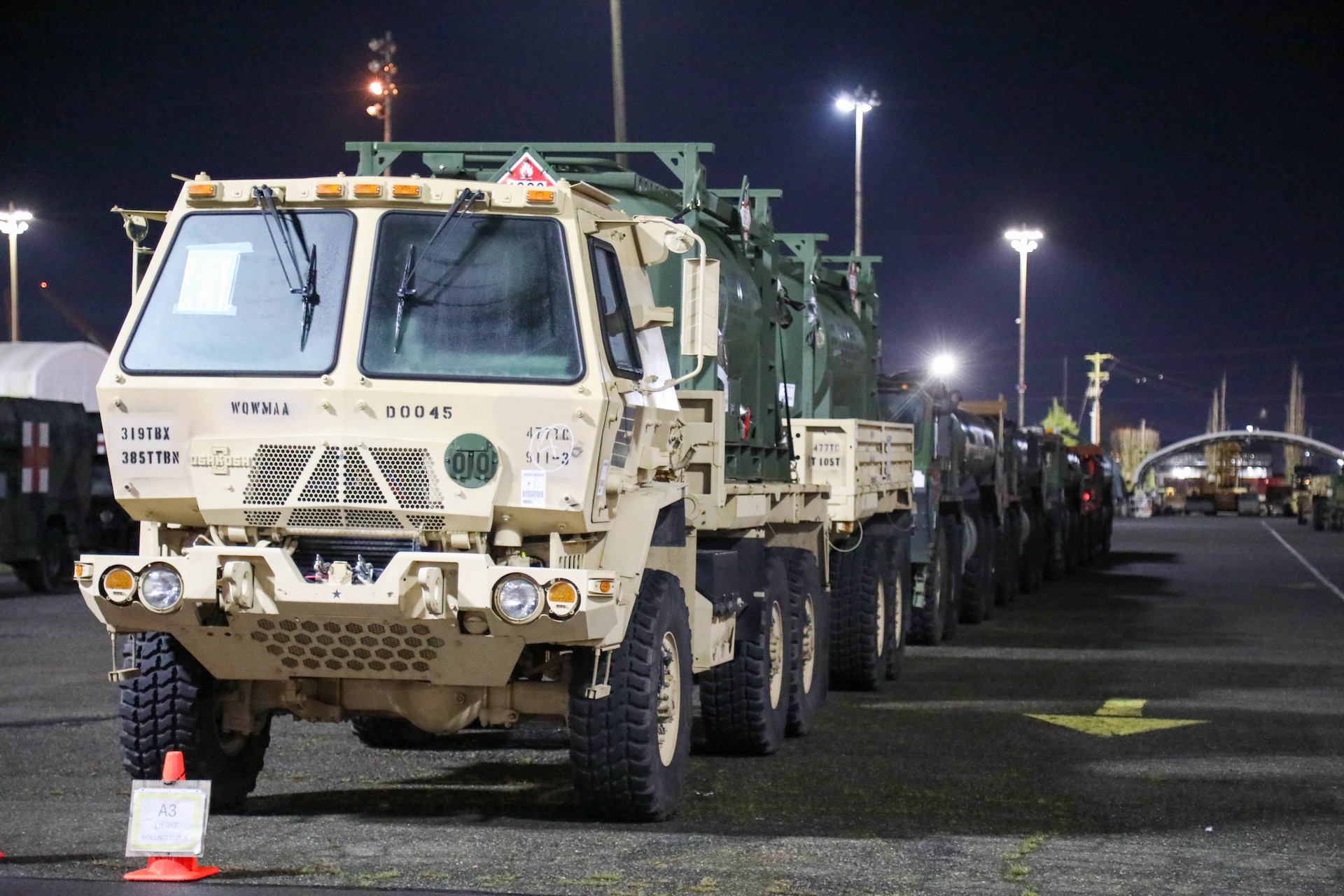 A U.S. Army Reserve M1083 Medium Tactical Vehicle with trailer carrying fuel tanks, assigned to 477th Inland Cargo Transportation Company, 385th Transportation Terminal Battalion, 364th Expeditionary Sustainment Command, stages at the Port of Tacoma, Washington, prior to forward positioning in the Indo-Pacific region, Feb. 4, 2026. The 364th Expeditionary Sustainment Command is headquartered in Marysville, Washington, and is regionally aligned to U.S. Indo-Pacific Command, providing logistical and sustainment support across seven western states and the Indo-Pacific region. (U.S. Army Photo by Maj. India Hunter)