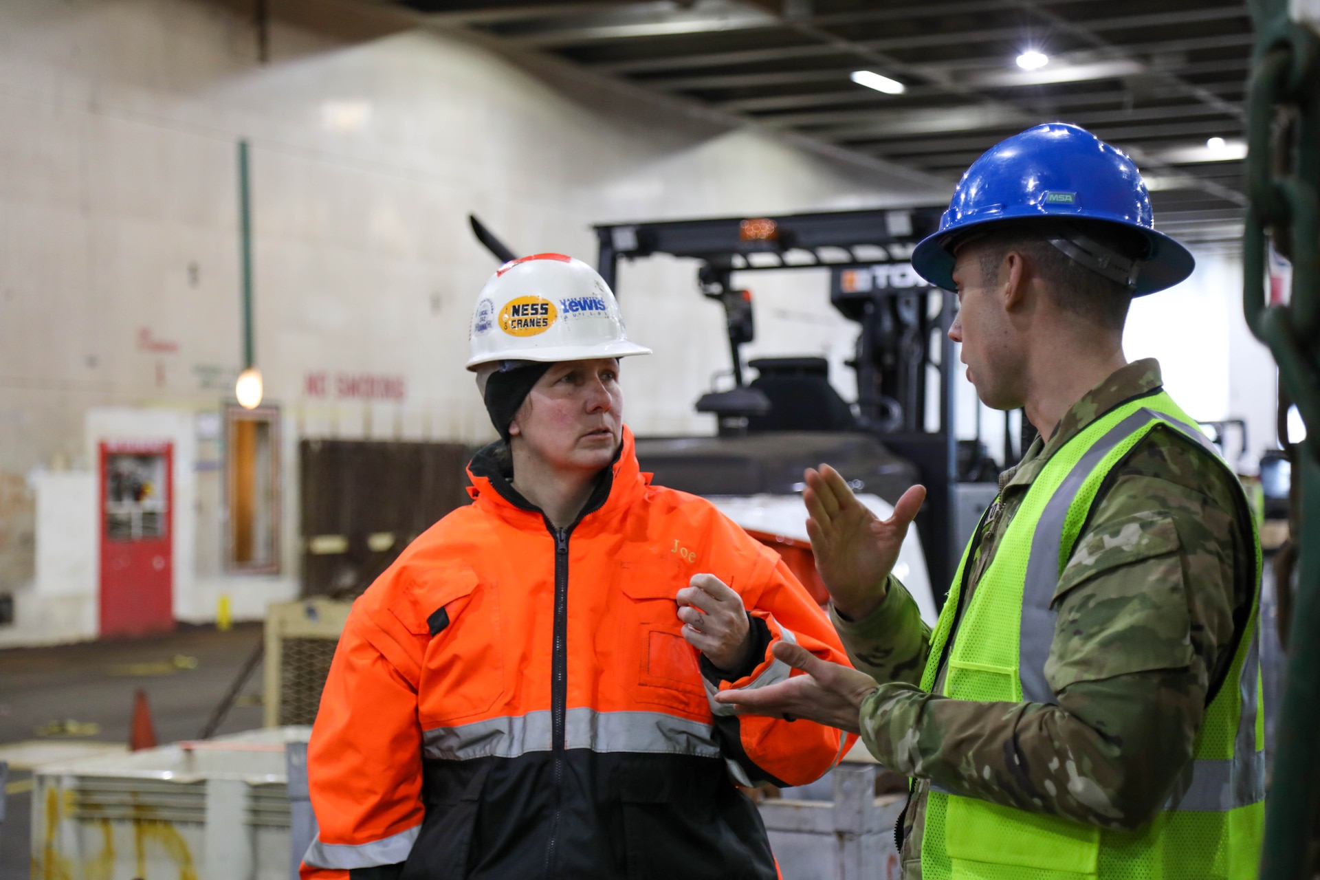U.S. Army Reserve Chief Warrant Officer 4 Tami Hatch, distribution management center mobility warrant officer, 364th Expeditionary Sustainment Command, speaks with Master Sgt. Matthew Squatrito, battalion senior maintenance supervisor, 385th Transportation Terminal Battalion, in the cargo deck of the MV Cape Horn (T-AKR-5068) at the Port of Tacoma, Washington, as equipment assigned to the 477th Inland Cargo Transportation Company is loaded aboard the vessel bound for the Indo-Pacific region, Feb. 4, 2026. The 364th Expeditionary Sustainment Command is headquartered in Marysville, Washington, and is regionally aligned to U.S. Indo-Pacific Command, providing logistical and sustainment support across seven western states and the Indo-Pacific region. (U.S. Army Photo by Maj. India Hunter)