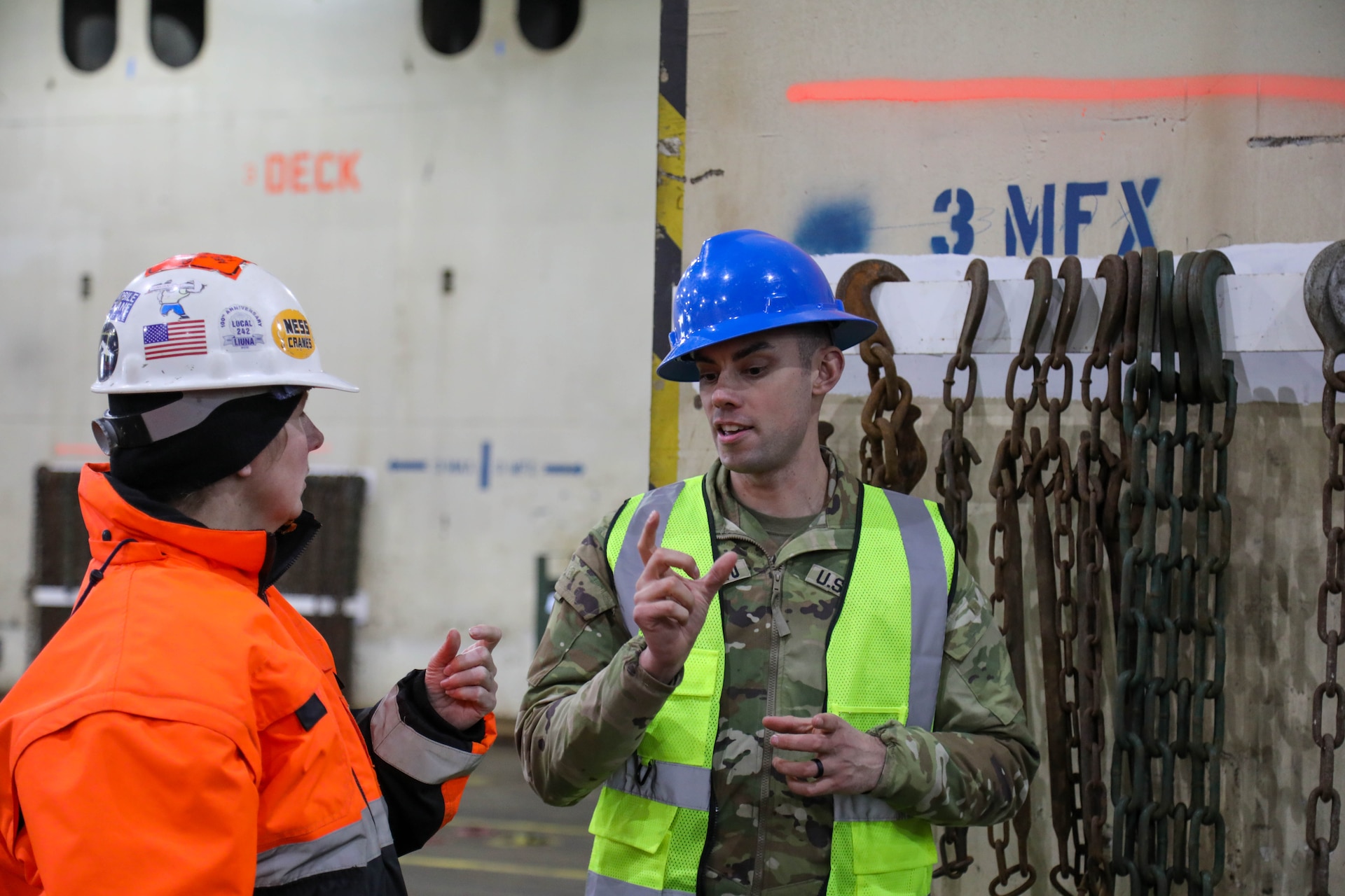 U.S. Army Reserve Master Sgt. Matthew Squatrito, battalion senior maintenance supervisor, 385th Transportation Terminal Battalion, speaks with Chief Warrant Officer 4 Tami Hatch, distribution management center mobility warrant officer, 364th Expeditionary Sustainment Command, in the cargo deck of the MV Cape Horn (T-AKR-5068) at the Port of Tacoma, Washington, as equipment assigned to the 477th Inland Cargo Transportation Company is loaded aboard the vessel bound for the Indo-Pacific region, Feb. 4, 2026. The 364th Expeditionary Sustainment Command is headquartered in Marysville, Washington, and is regionally aligned to U.S. Indo-Pacific Command, providing logistical and sustainment support across seven western states and the Indo-Pacific region. (U.S. Army Photo by Maj. India Hunter)