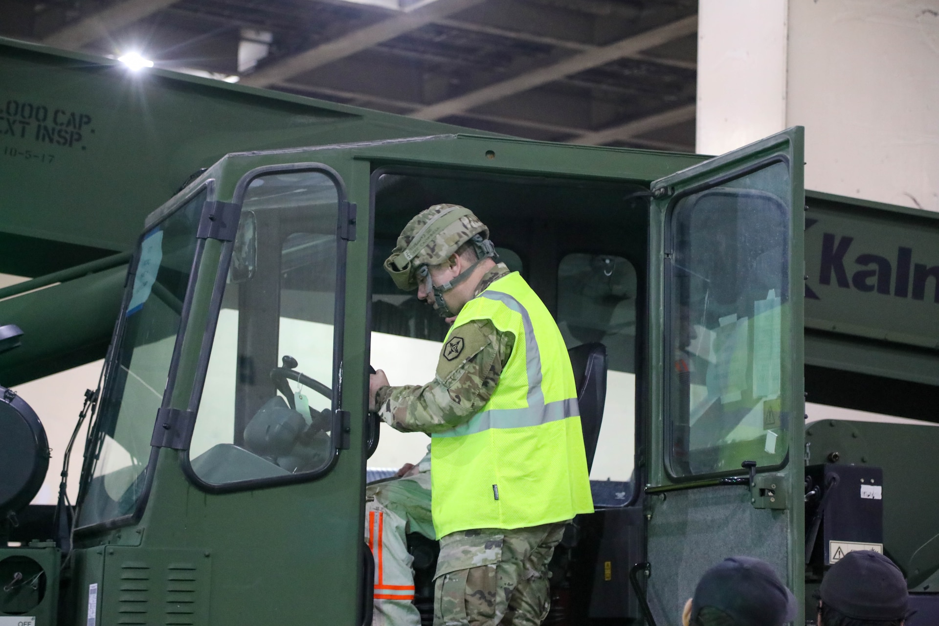 U.S. Army Reserve Sgt. 1st Class Jonathan Campbell outside the cab of the Kalmar TRA240 Rough Terrain Container Handler, assisting with placement in the cargo deck of the MV Cape Horn (T-AKR-5068) at the Port of Tacoma, Washington, as equipment assigned to the 477th Inland Cargo Transportation Company is secured aboard the vessel bound for the Indo-Pacific region, Feb. 4, 2026. The 364th Expeditionary Sustainment Command is headquartered in Marysville, Washington, and is regionally aligned to U.S. Indo-Pacific Command, providing logistical and sustainment support across seven western states and the Indo-Pacific region. (U.S. Army Photo by Maj. India Hunter)