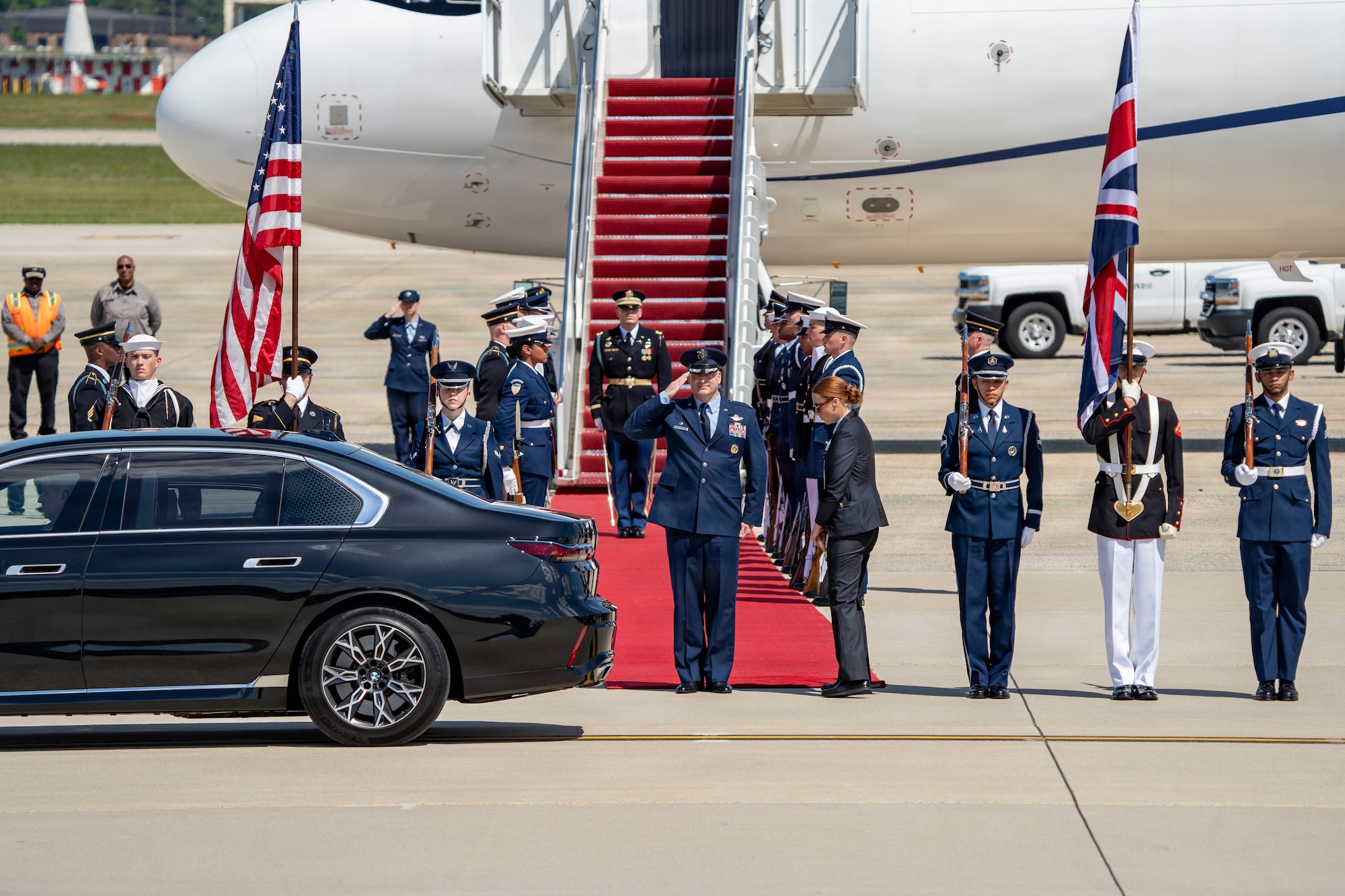 U.S. Air Force Col. Christopher M. Robinson, commander of the 89th Airlift Wing, renders a salute to Their Majesties of the United Kingdom of Great Britain and Northern Ireland.