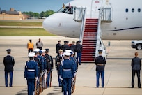 U.S. service members with an armed forces full honor cordon and Department of War security personnel stand in front of a United Kingdom aircraft.