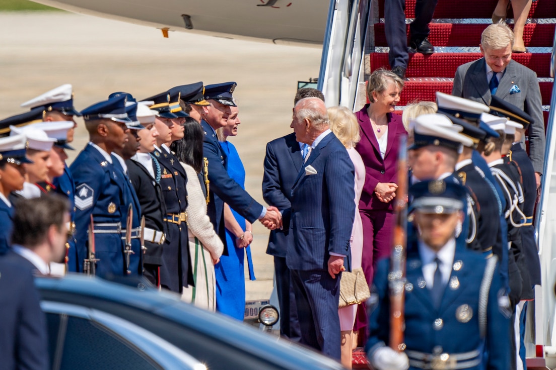 U.S. Air Force Col. Christopher M. Robinson, commander of the 89th Airlift Wing, shakes hands with His Majesty of the United Kingdom of Great Britain and Northern Ireland, King Charles III.