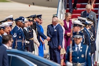 U.S. Air Force Col. Christopher M. Robinson, commander of the 89th Airlift Wing, shakes hands with His Majesty of the United Kingdom of Great Britain and Northern Ireland, King Charles III.