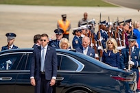 Their Majesties of the United Kingdom of Great Britain and Northern Ireland, King Charles III and Queen Camilla, prepare to enter a motorcade.
