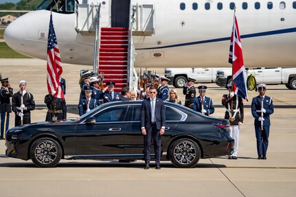 Their Majesties of the United Kingdom of Great Britain and Northern Ireland, King Charles III and Queen Camilla, prepare to enter a motorcade.
