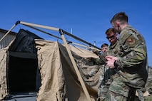 U.S. Airmen assigned to the 31st Combat Air Base Squadron establish a tactical operations center during exercise Freedom Flag 26-1 at Kunsan Air Base, Republic of Korea, April 15, 2026. The 31 CABS carried out agile combat employment, executing the mission from a dispersed location while maintaining centralized command and control. (U.S. Air Force photo by Senior Airman Ty Pilgrim)