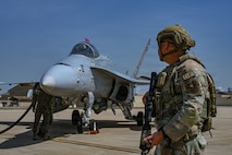 A U.S. Airman assigned to the 31st Combat Air Base Squadron provides security for a U.S. Marine Fighter Attack Squadron (VMFA) 232 F/A-18 Hornet during exercise Freedom Flag 26-1 at Kunsan Air Base, Republic of Korea, April 16, 2026. Training in joint and combined environments ensures the force remains ready, adaptable and aligned with evolving national defense priorities. (U.S. Air Force photo by Senior Airman Ty Pilgrim)