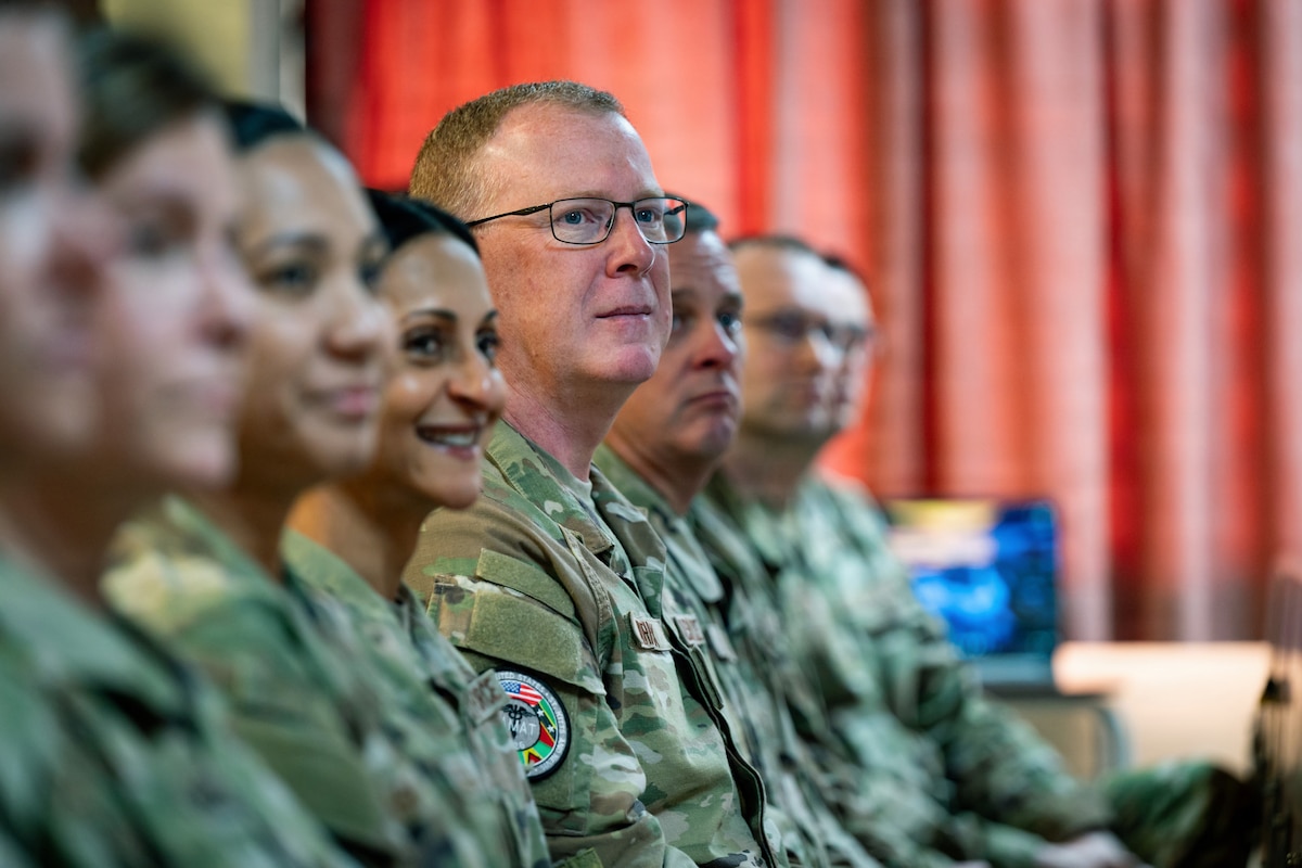 Image of people listening to a speech.