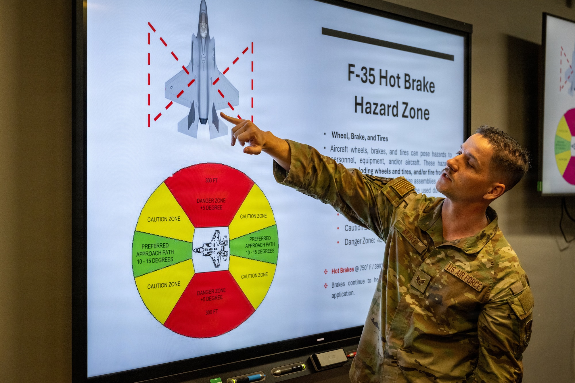 U.S. Air Force Staff Sgt. Matthew Muñoz, 13th Fighter Generation Squadron crew chief, briefs firefighters assigned to the 35th Civil Engineer Squadron on F-35 Lightning II hazard zones at Misawa Air Base, Japan, April 2, 2026.
