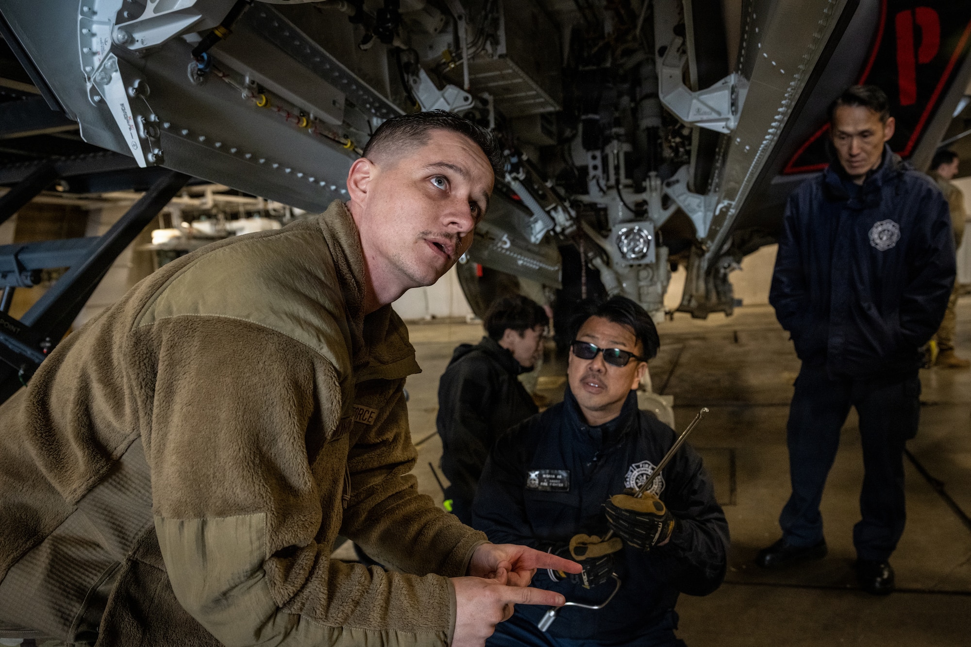 U.S. Air Force Staff Sgt. Matthew Muñoz, 13th Fighter Generation Squadron crew chief, showcases different parts of an F-35 Lightning II to firefighters assigned to the 35th Civil Engineer Squadron at Misawa Air Base, Japan, April 2, 2026.