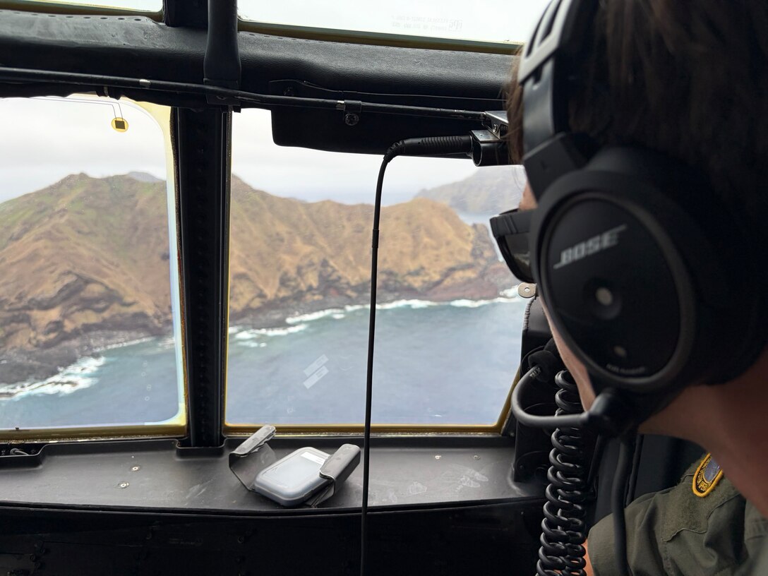 U.S. Coast Guard Petty Officer 3rd Class Antony Stark, an aviation maintenance technician assigned to Coast Guard Air Station Barbers Point in Kapolei, Hawaii, conducts an aerial search of Pagan in the Commonwealth of the Northern Mariana Islands April 27, 2026. Search efforts for the missing crew members of the cargo ship Mariana began after Joint Rescue Coordination Center Honolulu watchstanders lost communications with the vessel on April 15. (U.S. Coast Guard photo, courtesy Air Station Barbers Point)