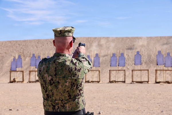 Cmdr. William “Bill” Lawson, acting executive officer, assigned to Navy Medicine Readiness and Training Command Twentynine Palms, fires the M9 service pistol during training at Marine Corps Air Ground Combat Center Twentynine Palms, Calif., March 26, 2026. (U.S. Navy photo by Christopher Jones, NMRTC/NH Twentynine Palms public affairs officer)