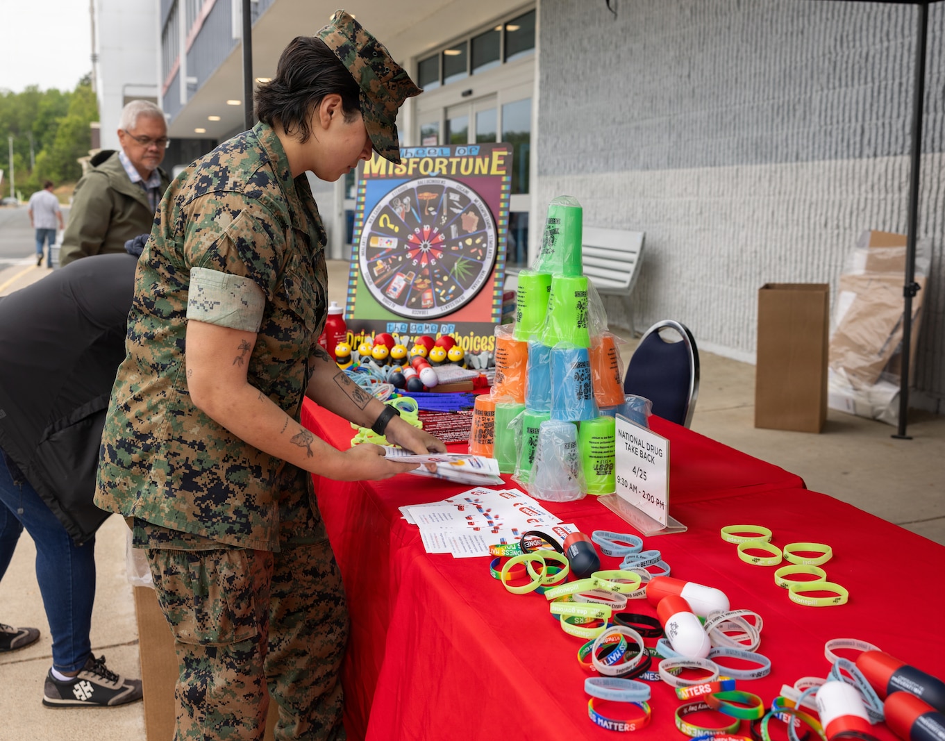 U.S. Marine Corps Lance Cpl. Gabrielle Angeles, a military police officer with Marine Corps Base Quantico Provost Marshall Office, prepares a table for the Drug Enforcement Administration Drug Take Back Program at the Marine Corps Exchange on MCB Quantico, Virginia, April 27, 2026. This program is hosted by the DEA to provide a safe, convenient, and responsible means of disposing expired and unused prescription medications. (U.S. Marine Corps photo by Sgt. Chancellor Reynolds)