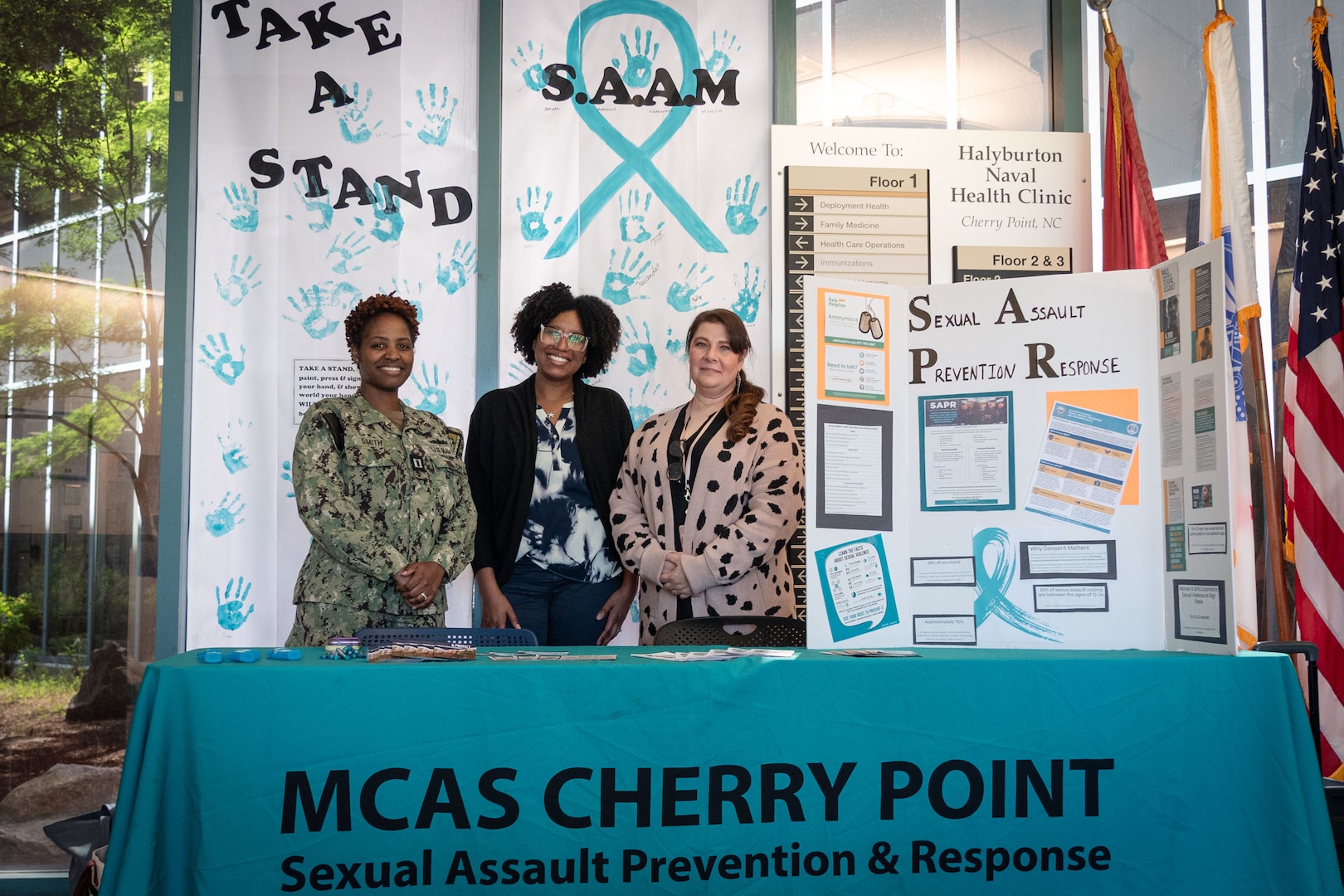 Navy Lt. Kabresha Smith, left, joins members of the Marine Corps Air Station Cherry Point Sexual Assault Prevention and Response Team at an interactive display inside Navy Medicine Readiness and Training Command Cherry Point on Monday, April 20, 2026.  Smith organized the “Take a Stand” display as part of the clinic’s observation of Sexual Assault Awareness and Prevention Month.