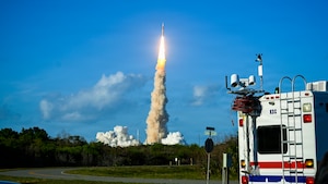 A NASA Space Launch System rocket launches the Artemis II mission from the Space Launch Complex at Kennedy Space Center with a KSC support truck in the foreground, Florida, April 1, 2026. Armed Forces Medical Examiner System medicolegal death investigators are present during crewed space launches along with other contingency planners and personnel from different agencies, including NASA medical officers, KSC medical support teams, and other regional medical units which make up an on-site triage team. They provide logistics and mass fatality management in the case of a contingency response. (courtesy photo)