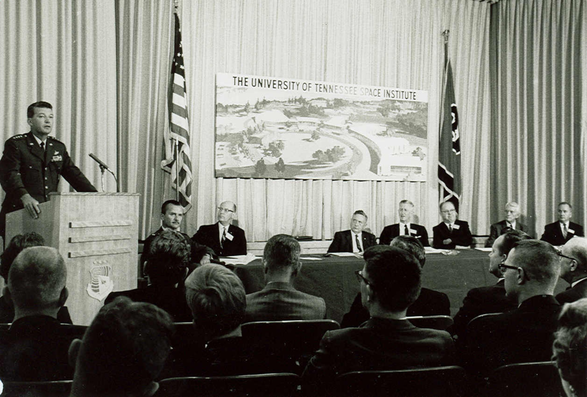 Gen. Bernard Schriever, commander of the Air Force Systems Command, address the first convocation of the University of Tennessee Space Institute on Sept. 25, 1964, one day after the first UTSI classes were held. In the years leading up to the establishment of UTSI, a program was in place through which the University of Tennessee would award graduate degrees to engineers at AEDC. Also pictured are Arnold Research Organization President R.M. Williams, left, and then-AEDC Commander Maj. Gen. William L. Rogers. (U.S. Air Force photo)