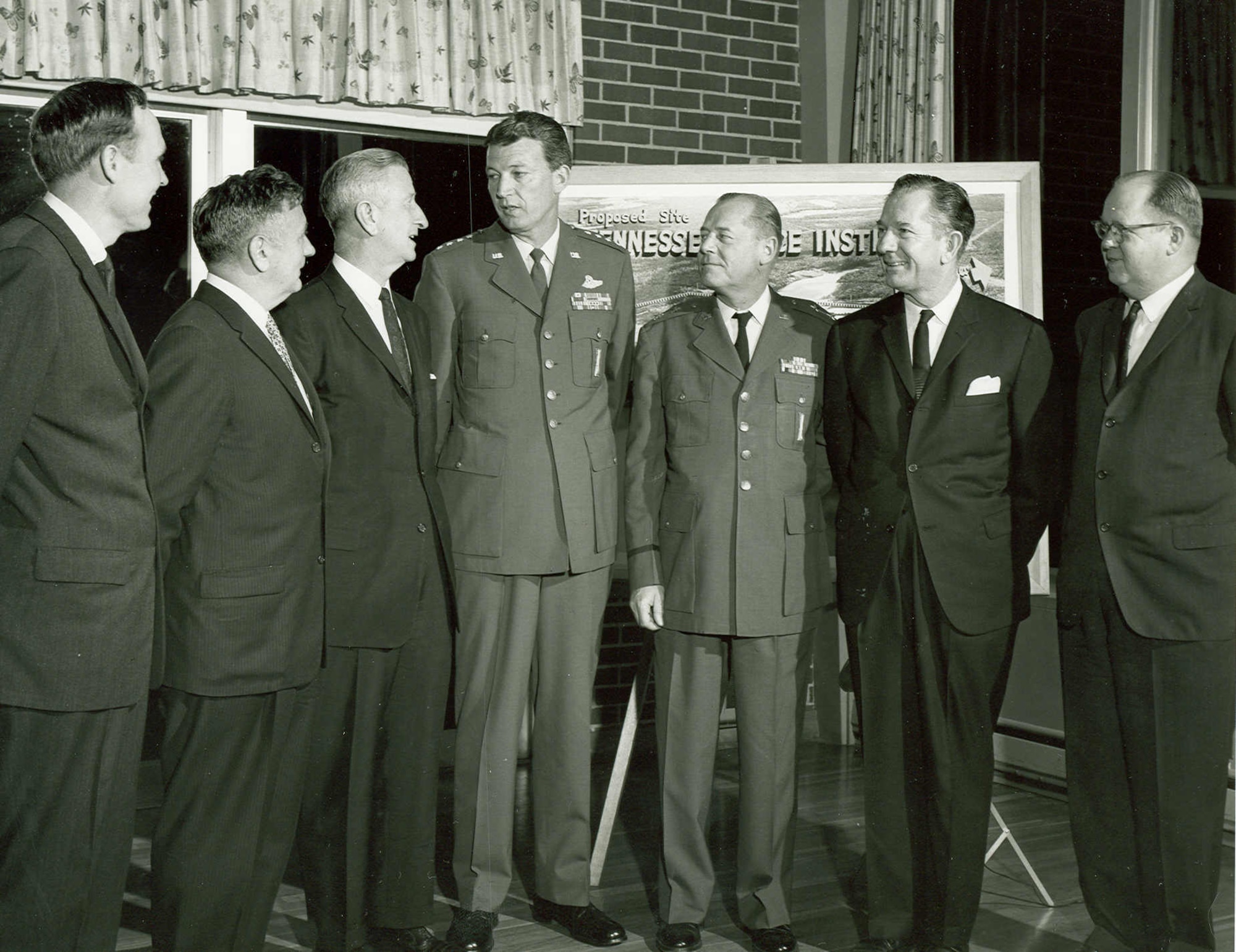 Gen. Bernard Schriever, commander of the Air Force Systems Command, center, speaks with other attendees of a 1963 dinner at Arnold Engineering Development Center during which the University of Tennessee Space Institute was discussed. The first UTSI classes were held Sept. 24, 1964, at AEDC in offices provided by the Air Force as UTSI was constructed. In the years leading up to the establishment of UTSI, a program was in place through which the University of Tennessee would award graduate degrees to engineers at AEDC. Pictured with Schriever, from left, are former State Sen. Ewing Threet, Arnold Research Organization Director of Engineering Bernhard Goethert, University of Tennessee President Andrew Holt, AEDC Commander Maj. Gen. William L. Rogers, Tennessee Lt. Gov. James Bomar and University of Tennessee Graduate Schools Dean A.A. Smith. (U.S. Air Force photo)