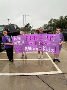 Students from Roberto “Bobby” Barrera Elementary School holds up a Month of the Military Child banner during the Purple Parade at Laughlin Air Force Base, Texas, April 15, 2026. The Department of War observes every April as Month of the Military Child to recognize children who grow up in military families. (Courtesy photo)