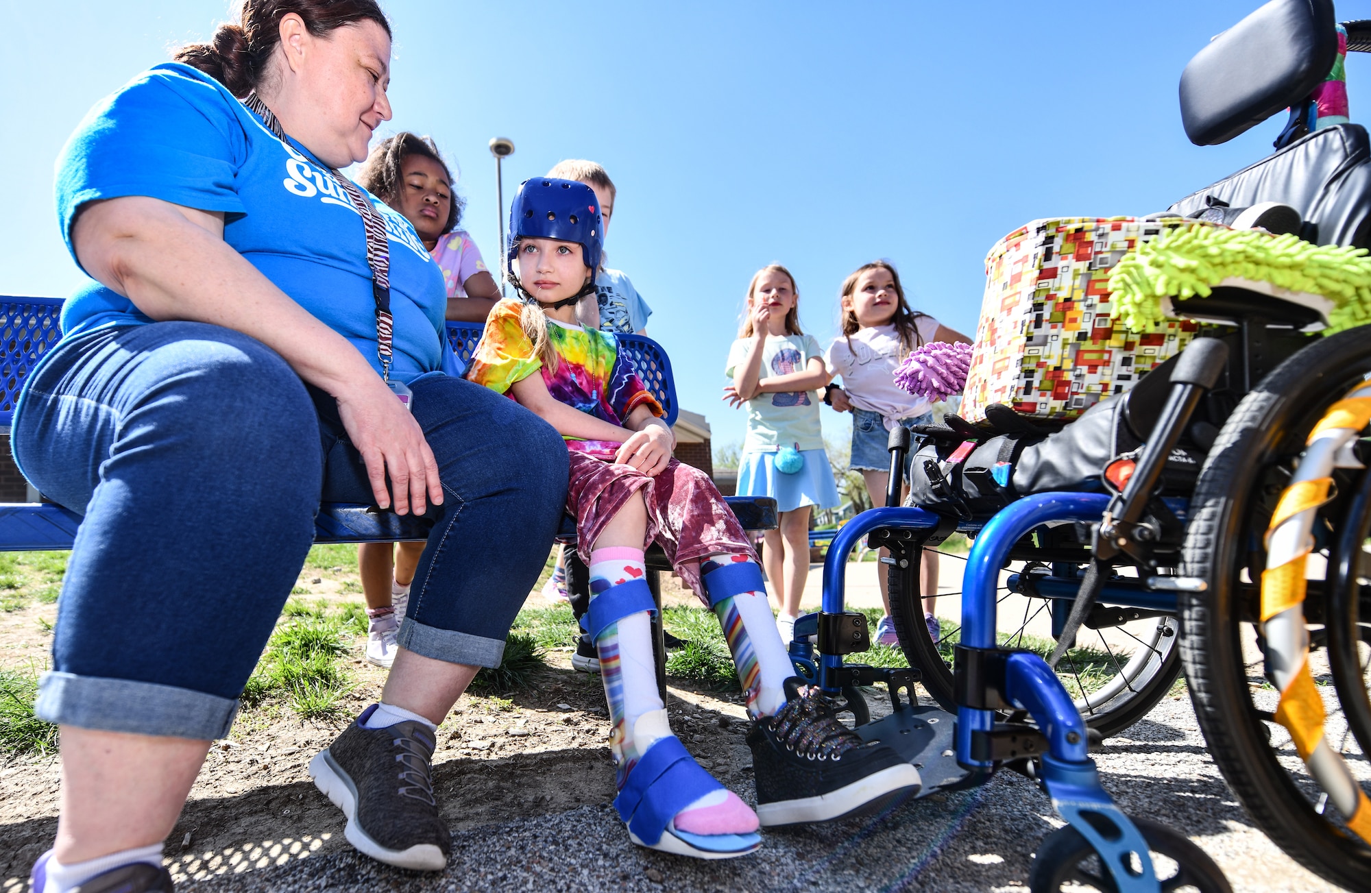 Veronica Bonilla sits with Hannah during recess at Leonard Lawrence Elementary on April 22, 2026. Hannah has multiple special education helpers throughout her day, ensuring that her needs are met while providing quality educational time. (U.S. Air Force photo by Chad Watkins)