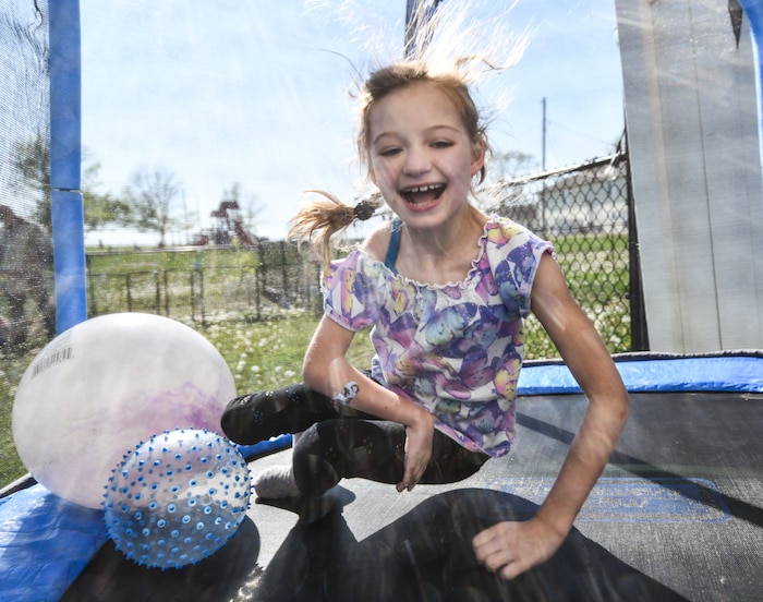 Hannah bounces on a trampoline in her backyard on April 24, 2026. Even with limited mobility from cerebral palsy, Hannah enjoys playing like everyone else. (U.S. Air Force photo by Chad Watkins)