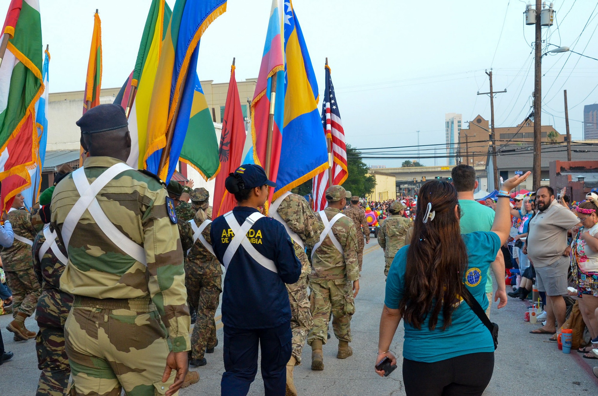 International Military Students and staff participate in the annual Fiesta Flambeau parade in San Antonio, Texas, April 25, 2026. Over 80 international students proudly represented their nations’ flags at the parade alongside DLIELC leadership and staff. Defense Language Institute English Language Center International Military Students and volunteers walked roughly three miles through the streets of downtown San Antonio as part of the Field Studies Program which helps strengthen English language skills and partnerships. (U.S. Air Force photo by Agnes Koterba)