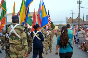 International Military Students and staff participate in the annual Fiesta Flambeau parade in San Antonio, Texas, April 25, 2026. Over 80 international students proudly represented their nations’ flags at the parade alongside DLIELC leadership and staff. Defense Language Institute English Language Center International Military Students and volunteers walked roughly three miles through the streets of downtown San Antonio as part of the Field Studies Program which helps strengthen English language skills and partnerships. (U.S. Air Force photo by Agnes Koterba)