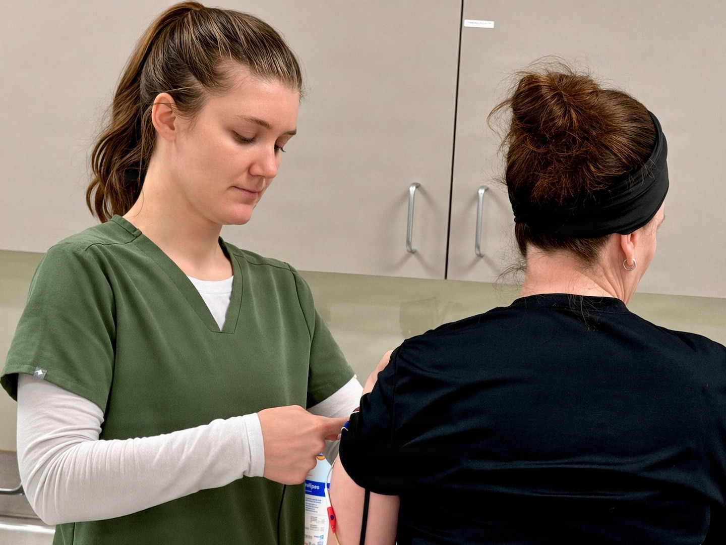 Occupational Therapist examines patient.