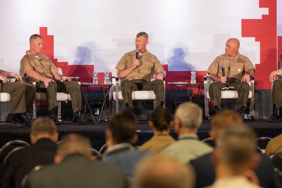 U.S. Marine Corps Maj. Gen. Kyle Ellison, left, Maj. Gen. John Jarrard, middle, and Maj. Gen. Farrell Sullivan, right, gives a speech during Modern Day Marine 2026, Walter E. Washington
Convention Center, Washington, DC, April 28, 2026. Modern Day Marine brings
together representatives from military, industry and government to collaborate in
shaping the future of the United States Marine Corps. Through the interactions taking
place at Modern Day Marine, the Corps is able to engage, educate and increase
understanding of the Marine Corps' contributions to the National Defense Strategy.
(U.S. Marine Corps photo by Cpl. Carlina Holland)