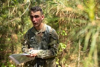 Cpl. Hunter Pressley, 15th Finance Battalion financial management technician, takes part in a land navigation exercise at the Mekong Delta day land navigation course on Fort Jackson, S.C., April 20, 2026. Twelve finance and comptroller Soldiers took part in the land navigation course on the first day of the U.S. Army Finance Corps’ annual Finance Soldier of the Year competition. (U.S. Army photo by Mark R. W. Orders-Woempner)