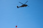 A UH-60 Black Hawk crew from Company G, 2-104th General Aviation Support Battalion, assists in fighting wildfires, April 23 – 25, 2026, near Broken Bow, Nebraska. The soldiers had originally planned on conducting a field training exercise in the area, but diverted assets to assist with real-world domestic operations needs. Photo by Tech. Sgt. Phil Cowen.