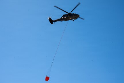 A UH-60 Black Hawk crew from Company G, 2-104th General Aviation Support Battalion, assists in fighting wildfires, April 23 – 25, 2026, near Broken Bow, Nebraska.